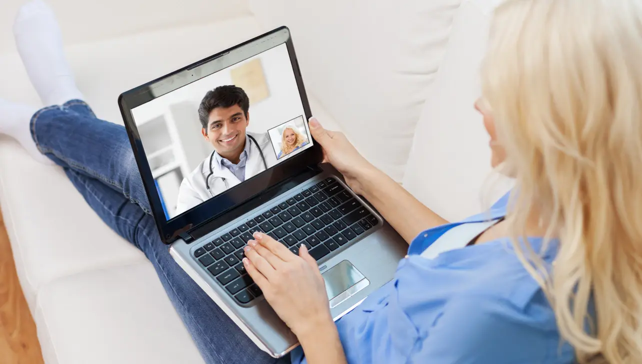Healthcare professional talking to deaf person via video call