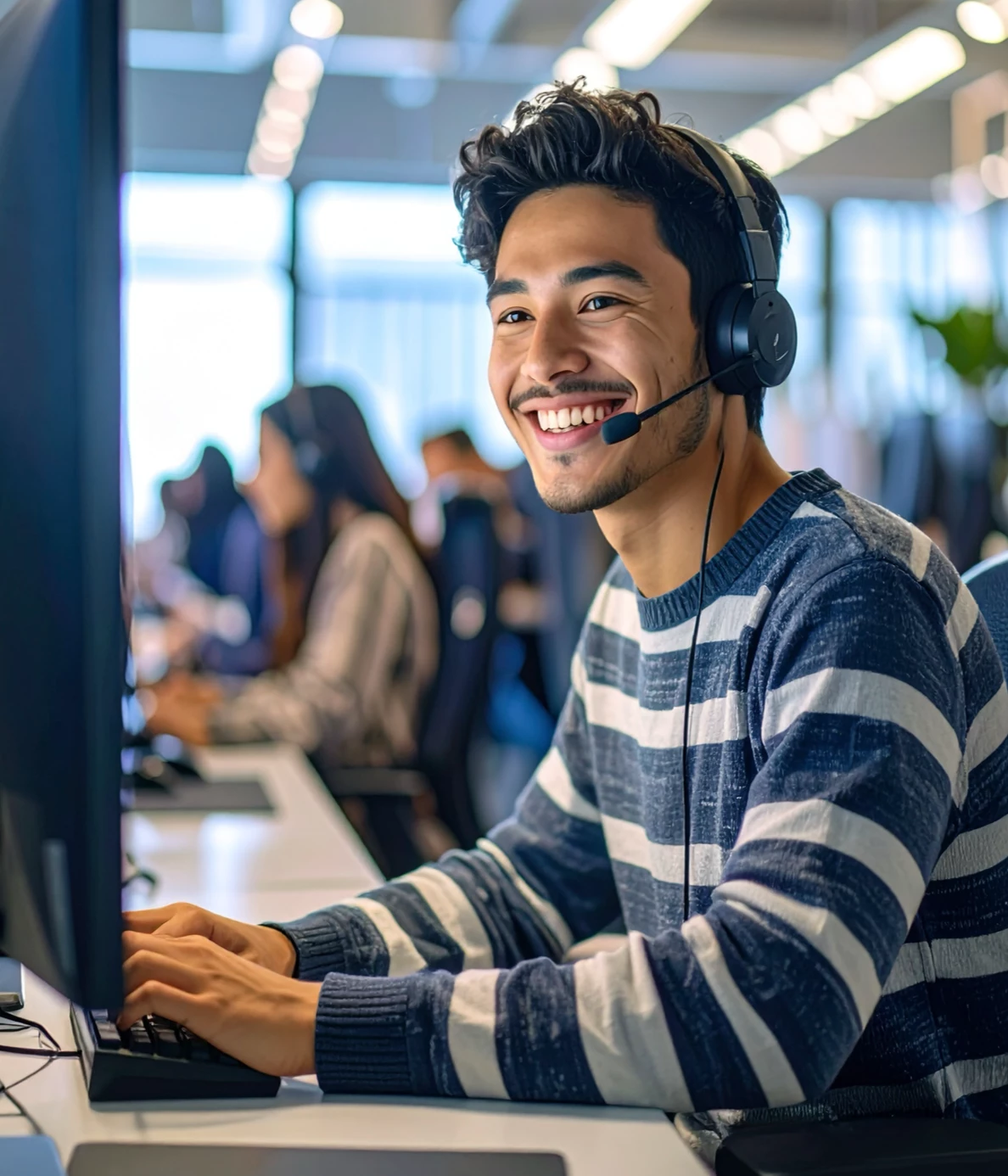 A man taking a customer service call in a call center