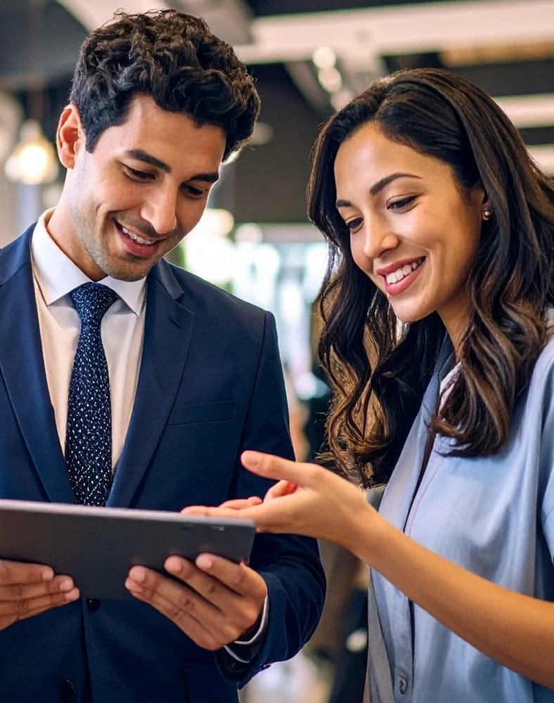 Two people looking at an iPad
